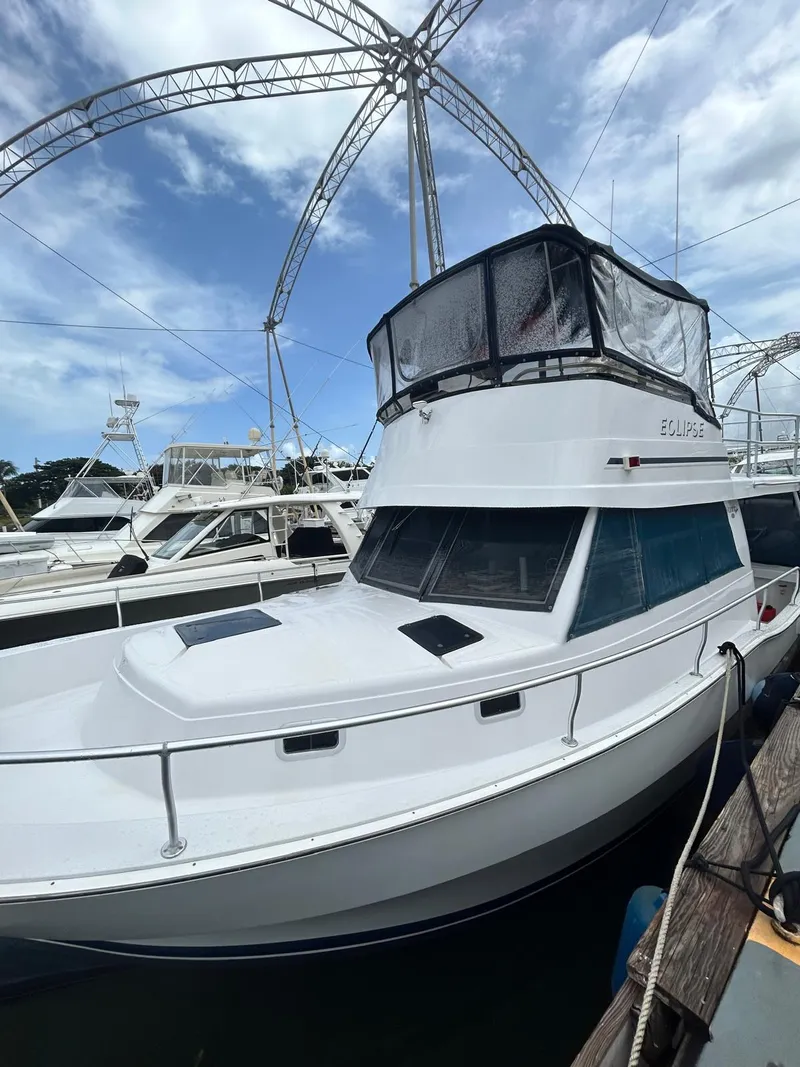 Slide: The Image of 1999 Mainship 350 Trawler docked under a clear blue sky. - 2