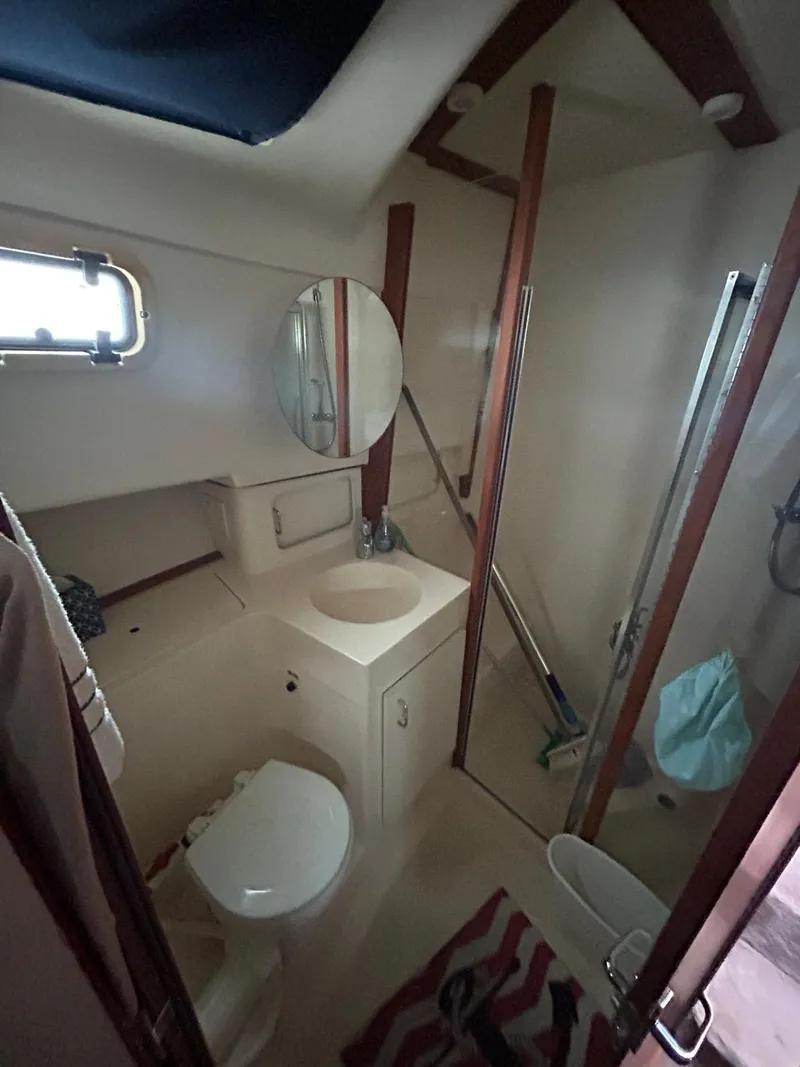 Slide: The Image of 1999 Mainship 350 Trawler bathroom with shower, sink, and toilet. - 8