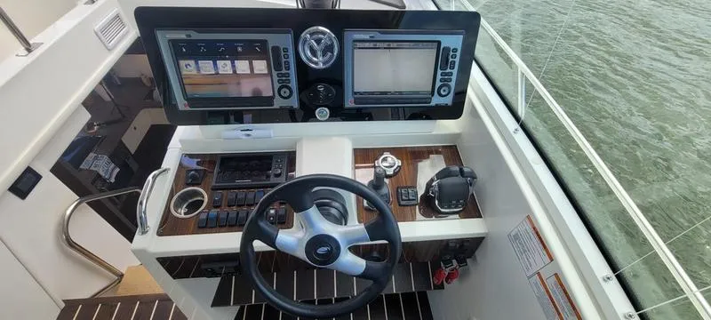 Slide: The Image of 2011 Cruisers Yachts 48 Cantius helm with dual displays and steering wheel. - 18