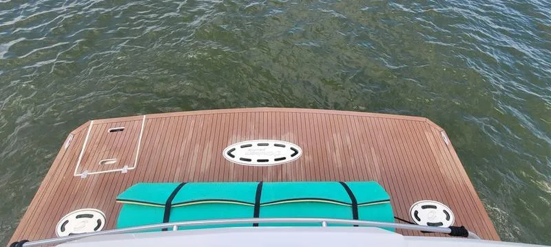 Slide: The Image of 2011 Cruisers Yachts 48 Cantius swim platform with teal mat on calm water. - 19