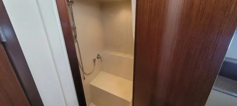 Slide: The Image of Shower area in 2011 Cruisers Yachts 48 Cantius, featuring sleek wooden paneling. - 25