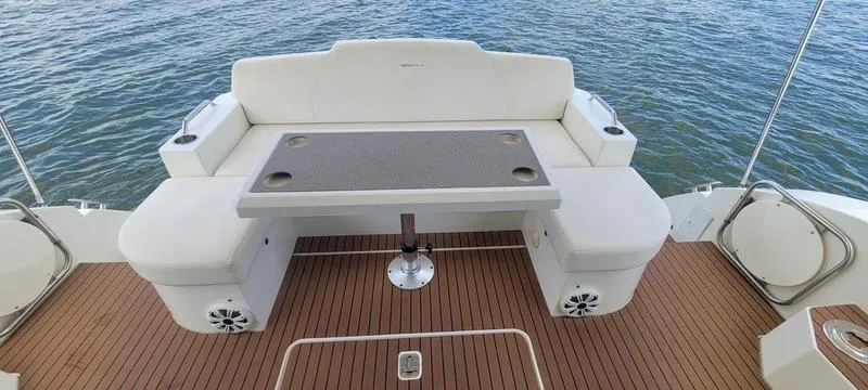 Slide: The Image of 2011 Cruisers Yachts 48 Cantius deck with seating and table, overlooking water. - 31