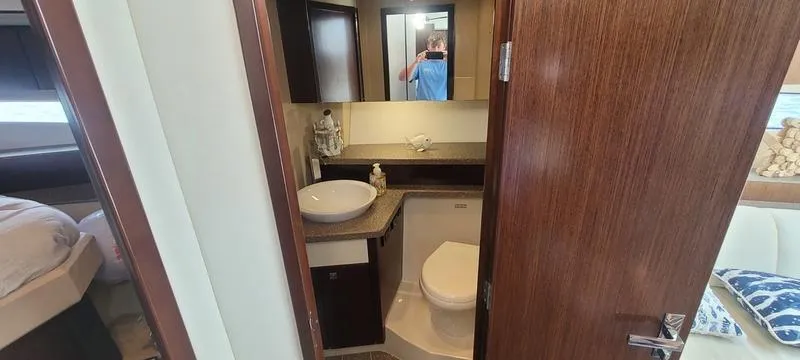 Slide: The Image of 2011 Cruisers Yachts 48 Cantius bathroom interior with modern fixtures and wood accents. - 33