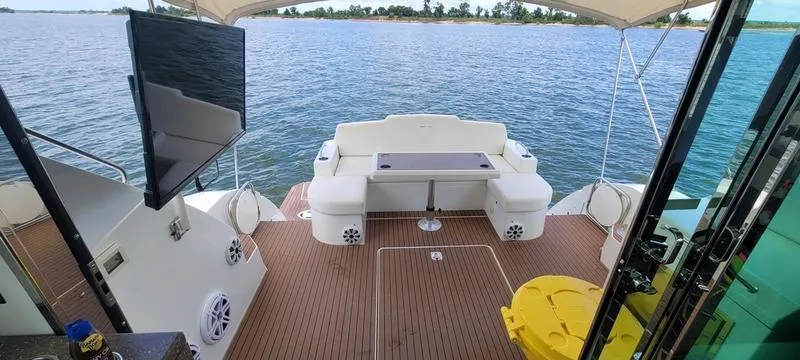Slide: The Image of Luxury 2011 Cruisers Yachts 48 Cantius deck with seating, TV, and scenic water view. - 39