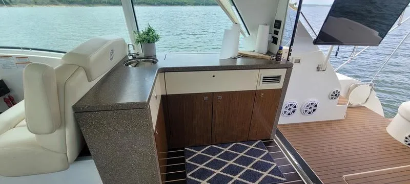 Slide: The Image of Luxurious 2011 Cruisers Yachts 48 Cantius interior with modern kitchenette and scenic water view. - 41