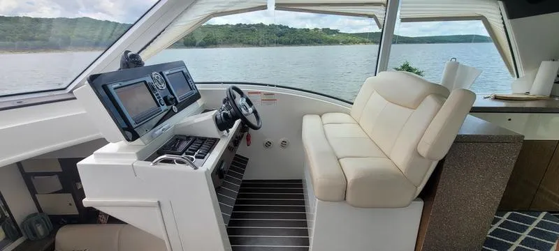 Slide: The Image of Interior helm of 2011 Cruisers Yachts 48 Cantius with scenic water view. - 46