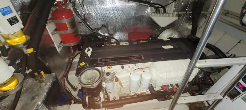 Slide: The Image of Engine room of 2011 Cruisers Yachts 48 Cantius with visible fire extinguisher and machinery. - 47