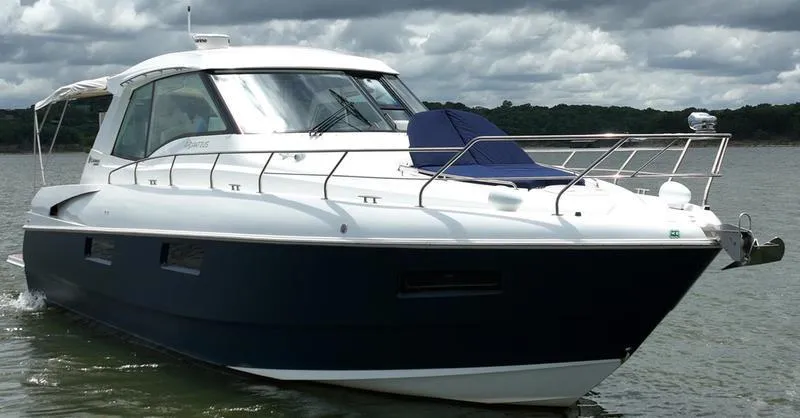 Slide: The Image of 2011 Cruisers Yachts 48 Cantius on water, sleek design, cloudy sky backdrop. - 48