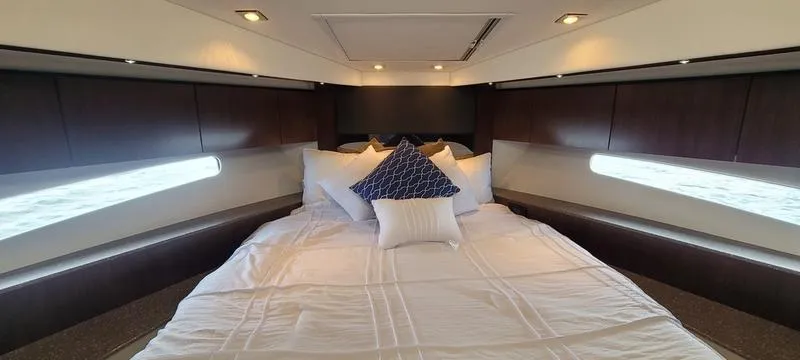 Slide: The Image of Luxurious bedroom interior of 2011 Cruisers Yachts 48 Cantius with elegant bedding and ambient lighting. - 49