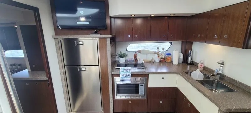 Slide: The Image of Luxurious kitchen in 2011 Cruisers Yachts 48 Cantius with modern appliances and sleek cabinetry. - 6