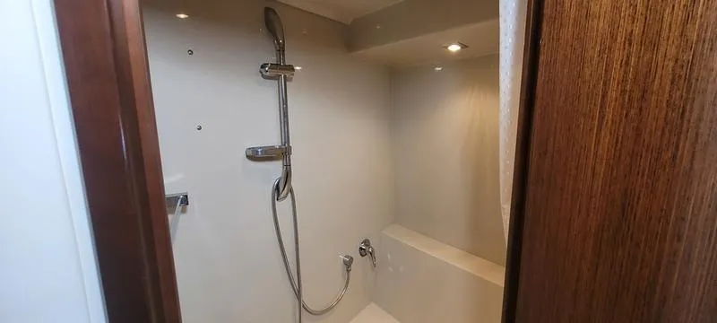 Slide: The Image of Shower area in 2011 Cruisers Yachts 48 Cantius, featuring modern fixtures and wood accents. - 7