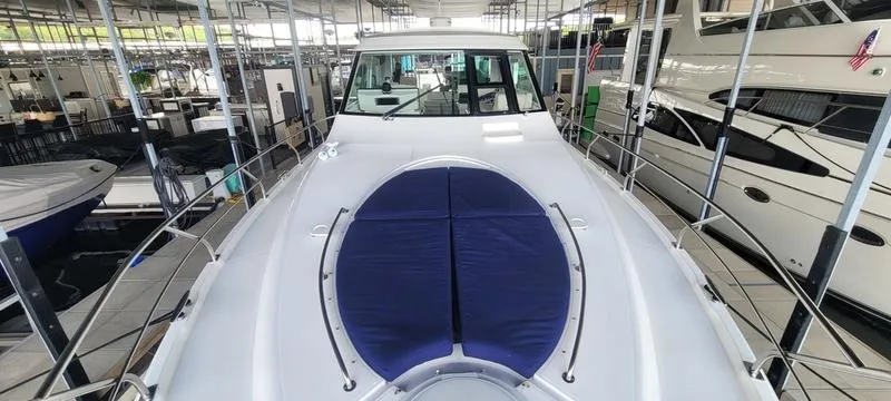 Slide: The Image of 2011 Cruisers Yachts 48 Cantius in showroom, showcasing sleek design and spacious deck. - 8