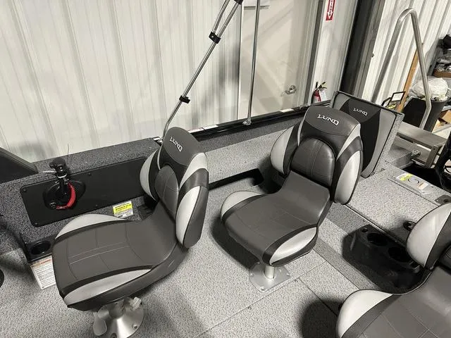 Slide: The Image of 2025 Lund 1775 Impact XS Sport boat interior with gray seating and modern design. - 10