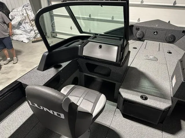 Slide: The Image of 2025 Lund 1775 Impact XS Sport boat interior with seating and storage compartments. - 11