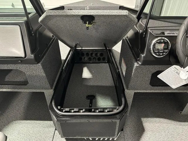 Slide: The Image of 2025 Lund 1775 Impact XS Sport boat interior with open storage compartment. - 15