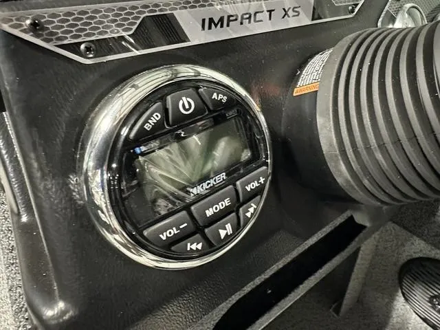 Slide: The Image of 2025 Lund 1775 Impact XS Sport boat dashboard with Kicker audio controls. - 17