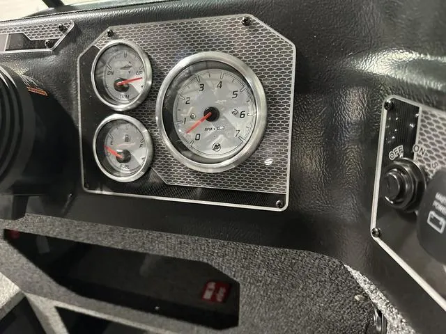 Slide: The Image of Dashboard of 2025 Lund 1775 Impact XS Sport boat with gauges and controls. - 18
