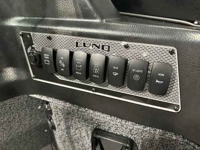 Slide: The Image of Control panel of 2025 Lund 1775 Impact XS Sport boat with labeled switches. - 19
