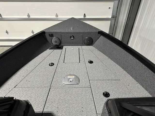 Slide: The Image of 2025 Lund 1775 Impact XS Sport boat interior with gray deck and storage compartments. - 20