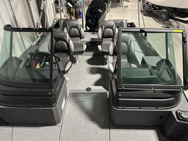 Slide: The Image of 2025 Lund 1775 Impact XS Sport boat interior with seating and windshield. - 23
