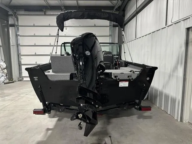 Slide: The Image of 2025 Lund 1775 Impact XS Sport boat in garage, rear view with motor. - 4