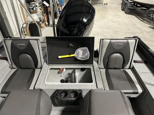 Slide: The Image of 2025 Lund 1775 Impact XS Sport boat interior with seating and storage compartments. - 6