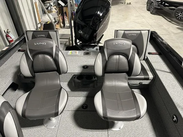 Slide: The Image of 2025 Lund 1775 Impact XS Sport boat interior with two gray seats. - 8