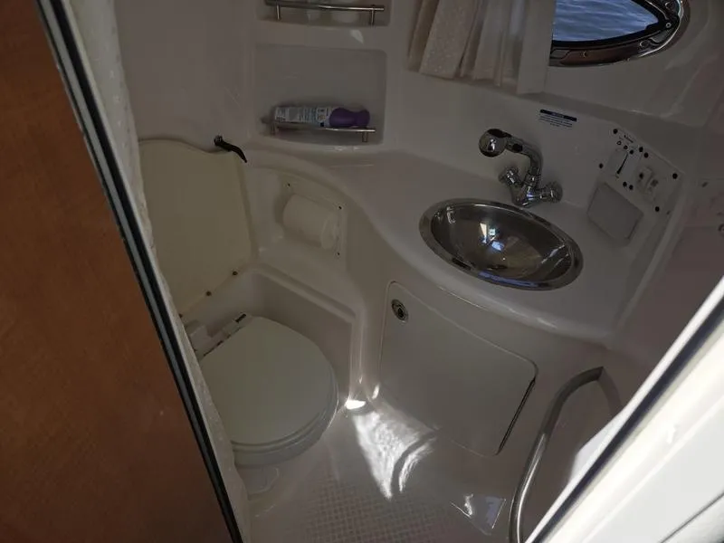 Slide: The Image of 2009 Chaparral 310 Signature boat bathroom with sink and toilet. - 11