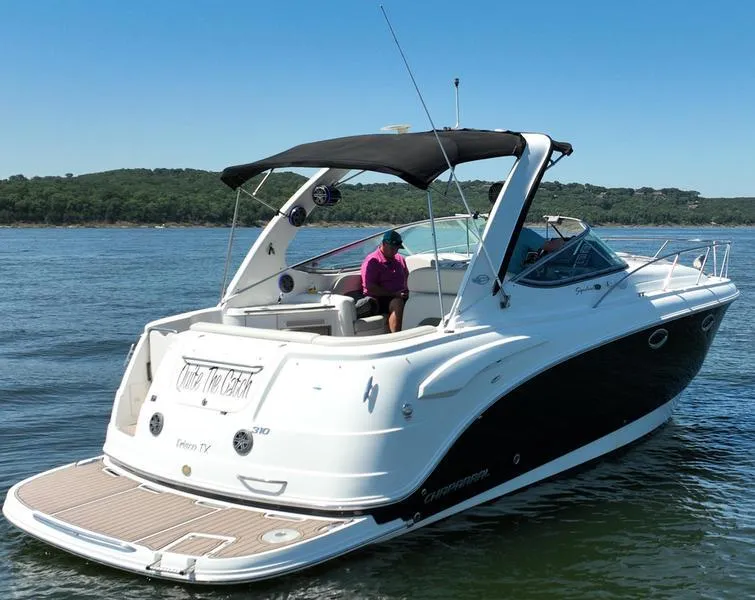 Slide: The Image of 2009 Chaparral 310 Signature boat cruising on a calm lake. - 15