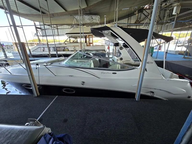 Slide: The Image of 2009 Chaparral 310 Signature boat docked in a marina. - 23