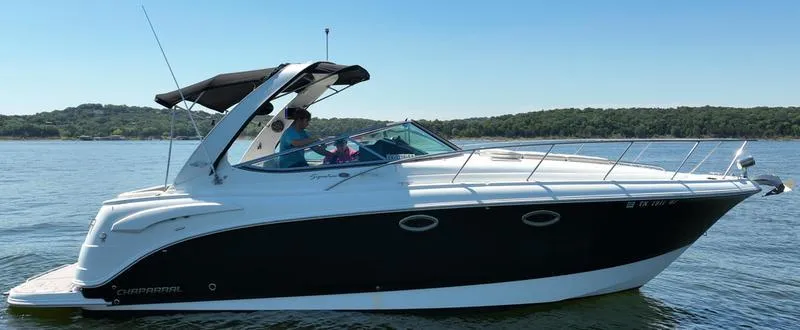 Slide: The Image of 2009 Chaparral 310 Signature boat cruising on a calm lake. - 31