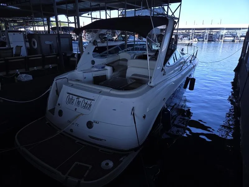 Slide: The Image of 2009 Chaparral 310 Signature boat docked in a marina. - 4
