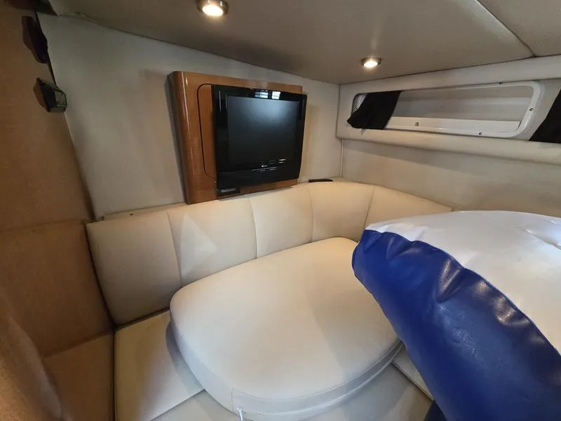 Slide: The Image of 2009 Chaparral 310 Signature cabin interior with TV and cushioned seating. - 5