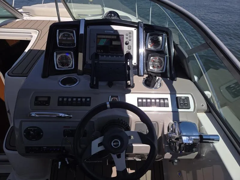 Slide: The Image of Cockpit of 2009 Chaparral 310 Signature boat with steering wheel and control panel. - 7