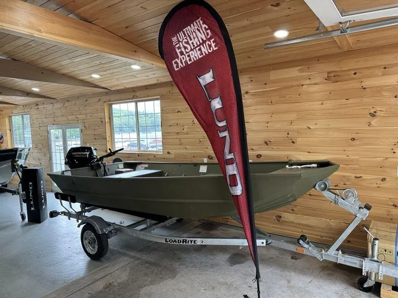 Slide: The Image of 2024 Lund 1448 Jon Tiller boat on trailer in showroom. - 1