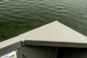 Slide: The Image of Bow of a 2024 Lund 1448 Jon Tiller on calm water. - 11