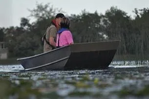 Slide: The Image of 2024 Lund 1448 Jon Tiller boat on a serene lake with two people enjoying a peaceful moment. - 7