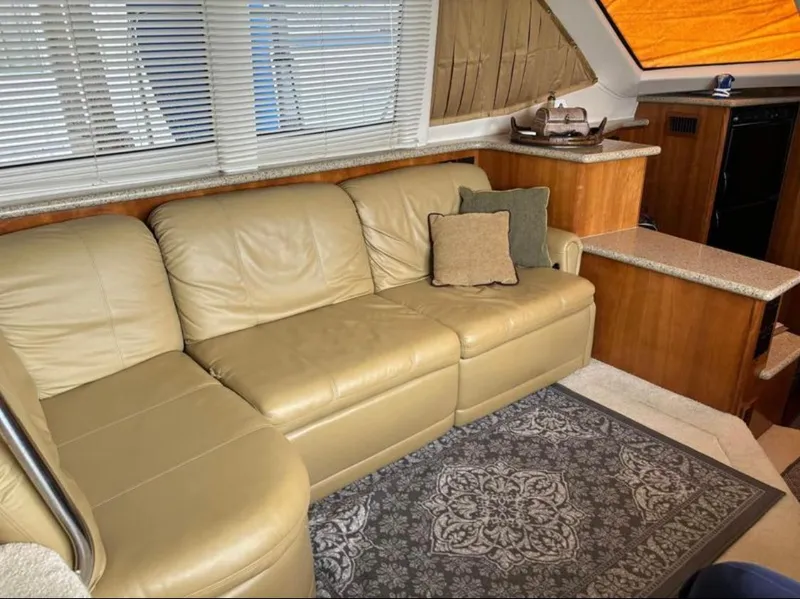 Slide: The Image of Luxurious interior of 2001 Carver 356 Motor Yacht with beige leather sofa and elegant decor. - 11