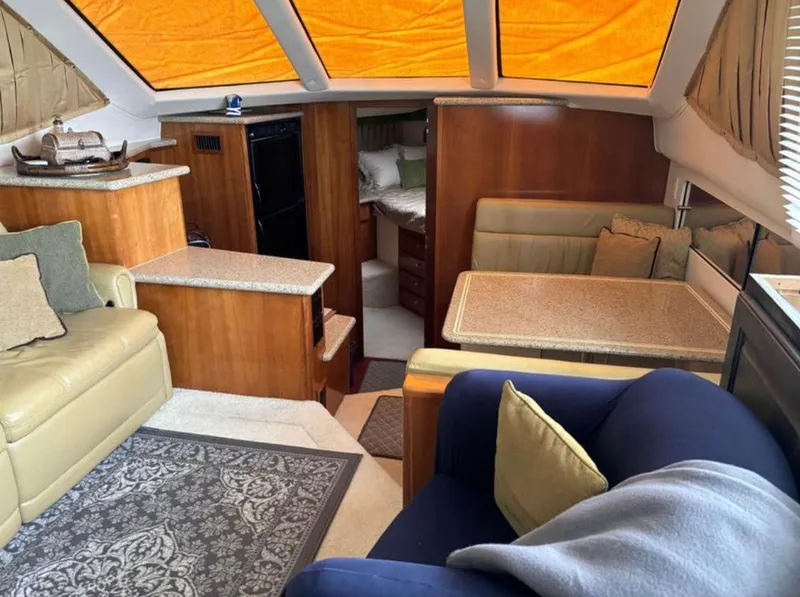 Slide: The Image of Interior of 2001 Carver 356 Motor Yacht with cozy seating and dining area. - 13