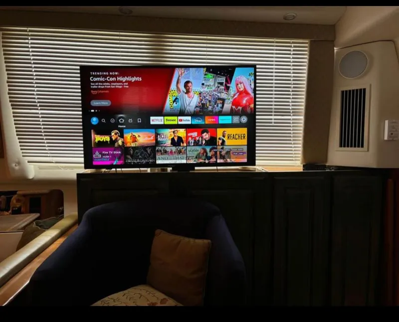 Slide: The Image of Entertainment setup inside 2001 Carver 356 Motor Yacht with TV displaying streaming services. - 14