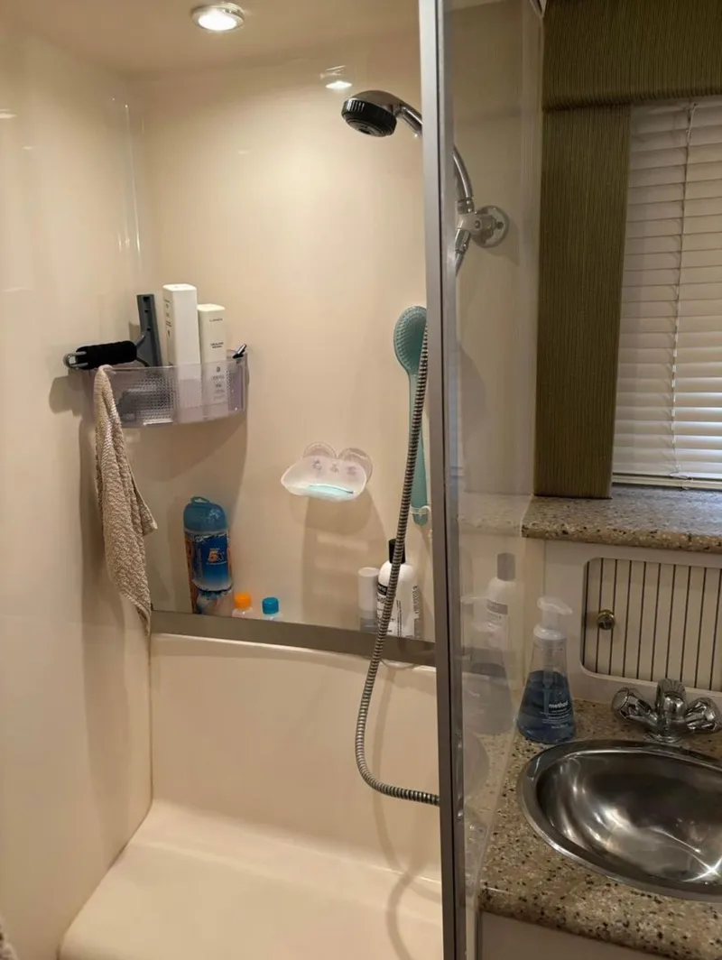 Slide: The Image of Shower area in 2001 Carver 356 Motor Yacht with sink and toiletries. - 21