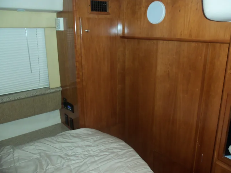 Slide: The Image of Interior cabin of 2001 Carver 356 Motor Yacht with wood paneling and bed. - 25