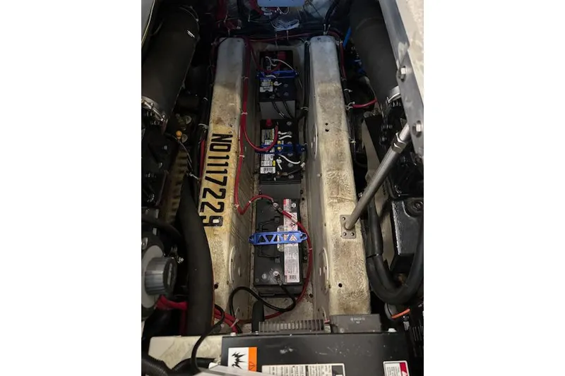 Slide: The Image of Engine compartment of a 2001 Carver 356 Motor Yacht, showing batteries and wiring. - 29