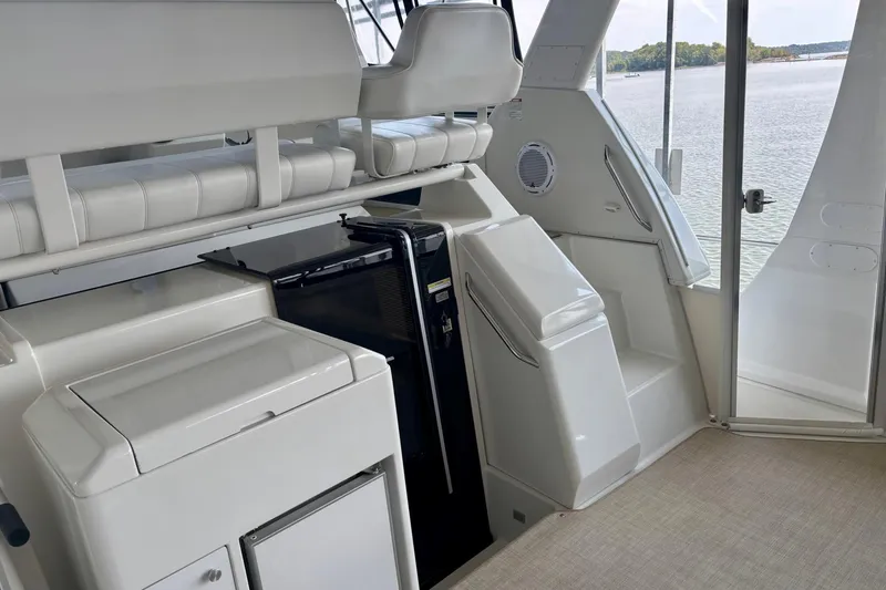 Slide: The Image of Interior of 2001 Carver 356 Motor Yacht with seating and storage, overlooking water. - 40