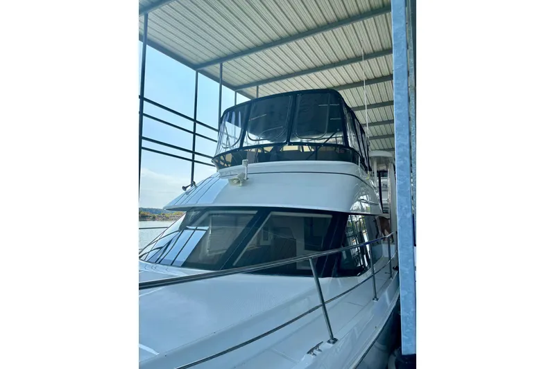 Slide: The Image of 2001 Carver 356 Motor Yacht docked under a covered marina. - 50