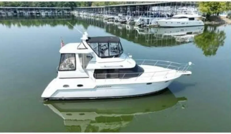 The Image of 2001 Carver 356 Motor Yacht on calm water near marina. - 0