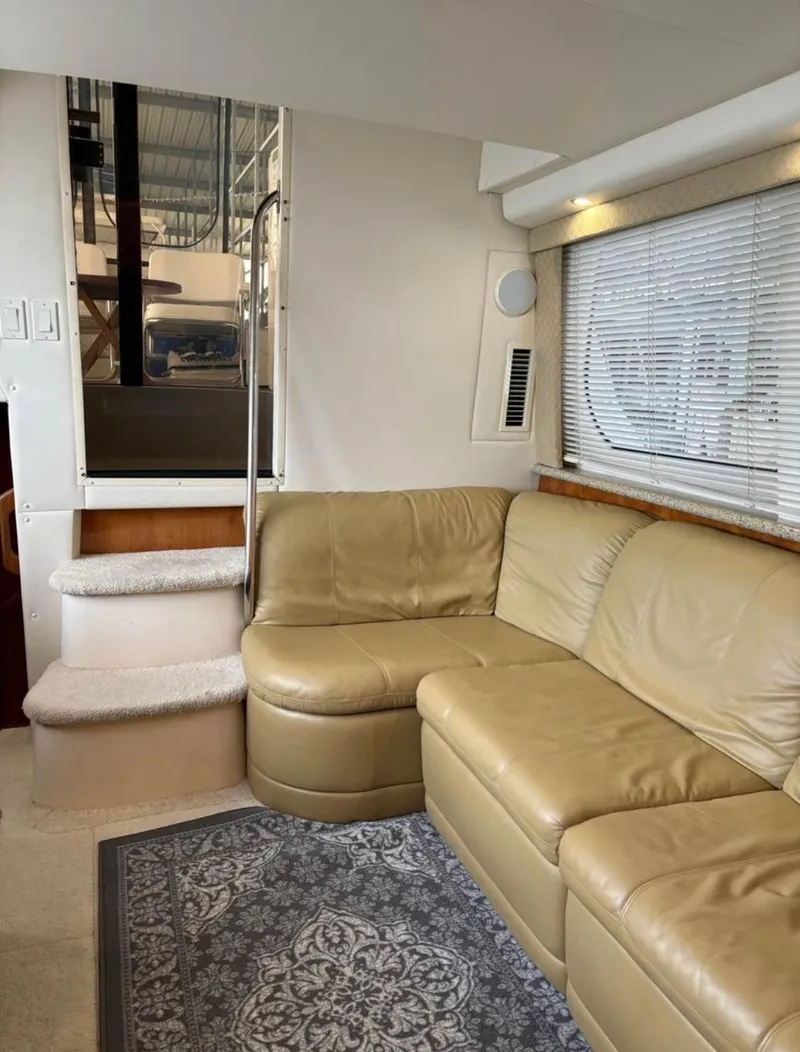 Slide: The Image of Interior of 2001 Carver 356 Motor Yacht with beige leather seating and carpeted steps. - 12