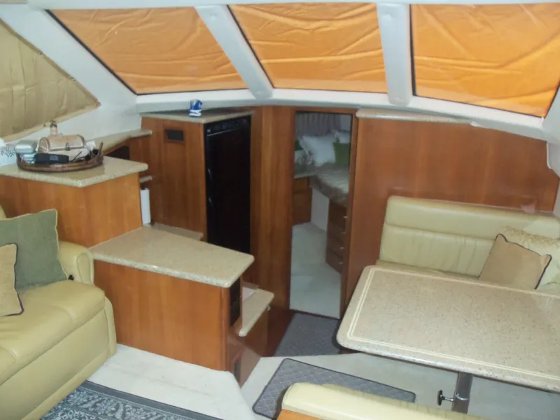 Slide: The Image of Interior of 2001 Carver 356 Motor Yacht with seating, table, and kitchenette. - 15