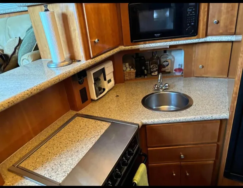 Slide: The Image of 2001 Carver 356 Motor Yacht kitchen with sink, stove, and microwave. - 16