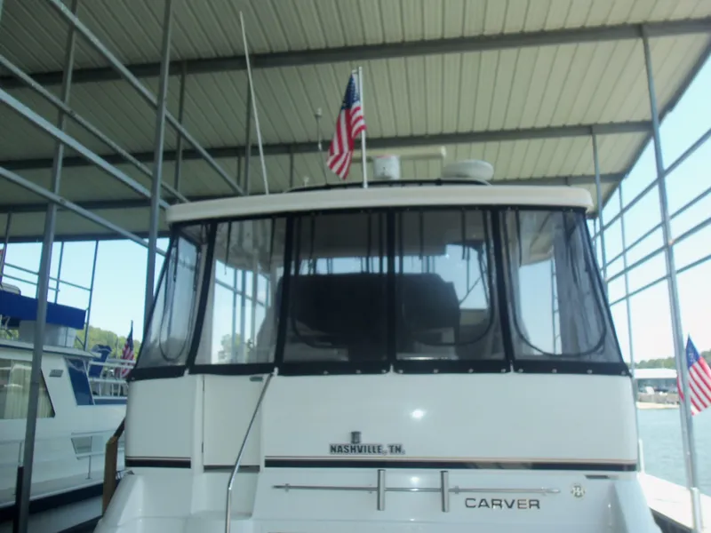 Slide: The Image of 2001 Carver 356 Motor Yacht docked under covered marina with American flag. - 2